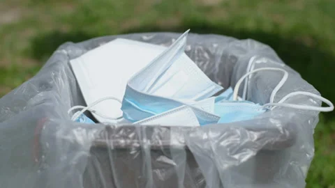 Man hand trashing protective mask on separate garbage bin,covid19 medical waste Video stock 150070113