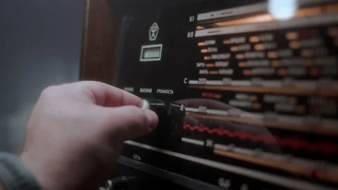 Man hand turn volume down old vintage radioll made in USSR, inscriptions in Stock Footage 237117839