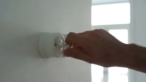 A man hand turning on and off a light switch in a house 스톡 동영상 71324006