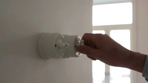 A man hand turning on and off a light switch in a house 스톡 동영상 71324198