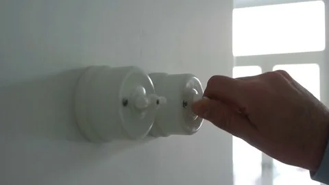 A man hand turning on and off a light switch in a house Video stock 71324314