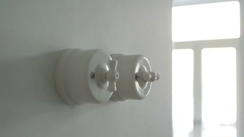 A man hand turning on and off a light switch in a house 스톡 동영상 71324473