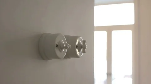 A man hand turning on and off a light switch in a house 스톡 동영상 71324694