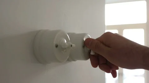 A man hand turning on and off a light switch in a house 스톡 동영상 71324760