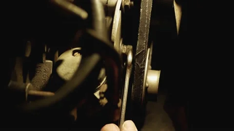 Man hand twists nut of the engine at night under lamp light Video stock 131406318