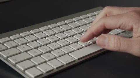 Man Hand typing at Apple White Keyboard Stock Footage 195293102