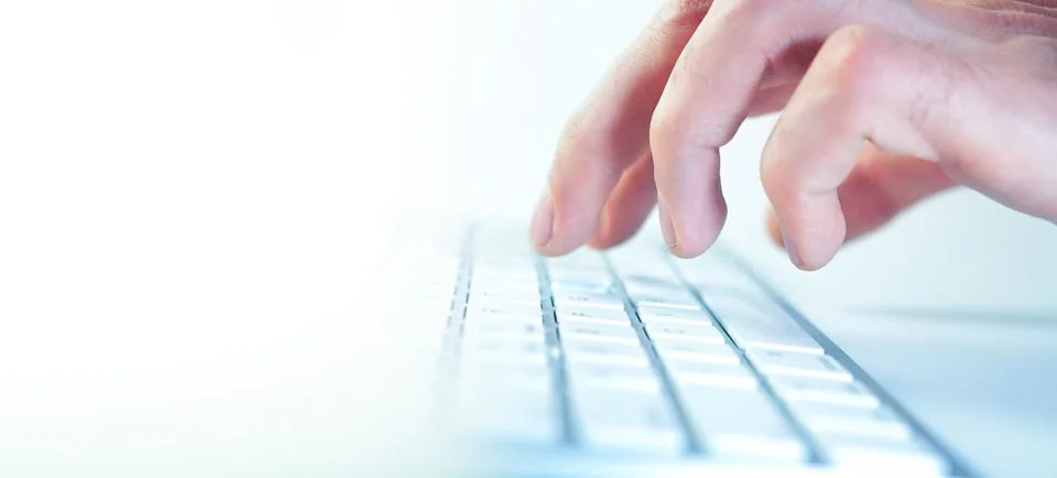 Man hand typing on computer keyboard Stock Photos