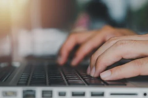 Man hand typing a computer laptop keyboard Stock Photos