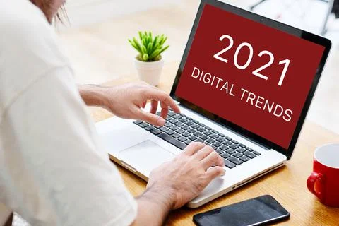 Man hand typing laptop computer with 2021 digital marketing trends on screen Stock Photos