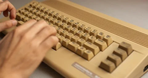 Man hand typing on old 8 bit computer from the 80's Stock Footage 188447913
