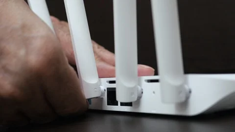 Man Hand Unplugging Blue Internet Cable From Wireless Router. Coils Of Ethernet  스톡 동영상 128552360