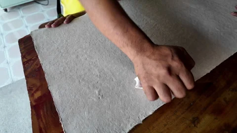 Man hand uses a stone to smooth the paper. Thai craft Stock Footage 276971068