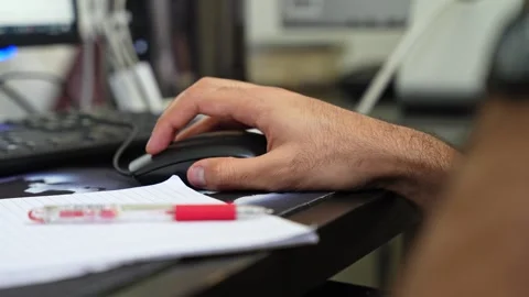 A man hand using a black computer mouse at a busy office Stock Footage 334408659