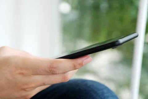 Man hand using black smart phone over blur  background, technology and lifest Stock Photos