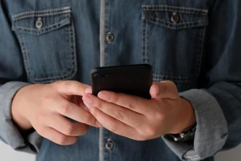 Man hand using black smart phone, people on phone, technology and lifestyle Stock Photos