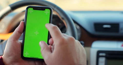 Man hand using chromakey mobile phone with empty green screen in modern car Stock Footage 165150267
