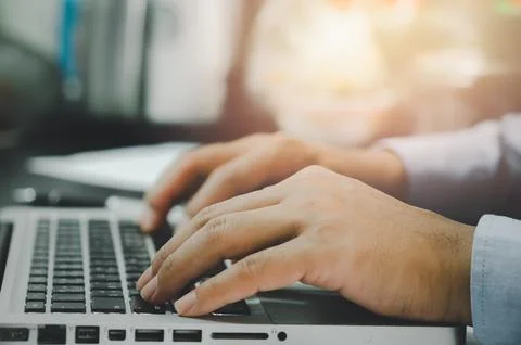 Man hand using computer laptop on table at home Stock Photos