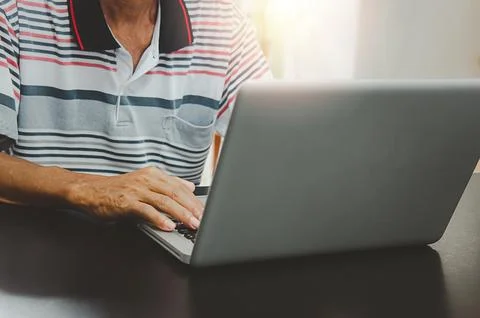 Man hand using computer laptop on table at home, searching information brow.. Stock Photos