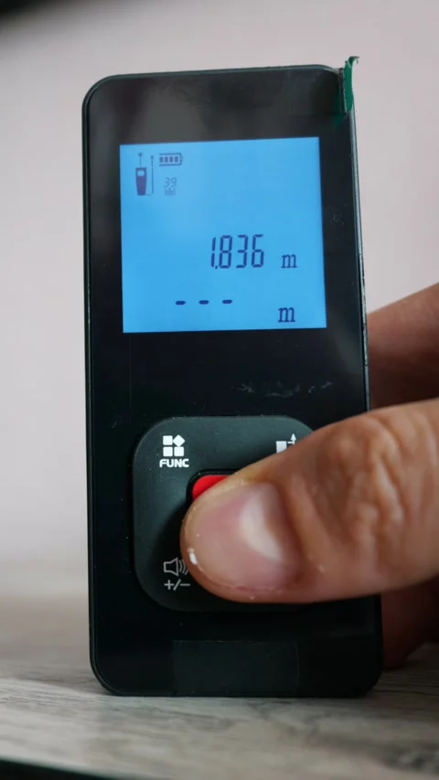 Man Hand Using Digital Laser Distance Meter in Modern Interior Stock Footage 339363268