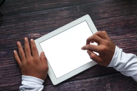 Man hand using digital tablet displaying white screen top down Foto stock
