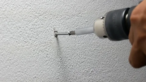 Man hand using electric screwdriver to tighten the screw into plastic plug , Stock Footage 89729909