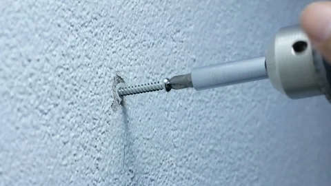 Man hand using electric screwdriver to tighten the screw into plastic plug , Stock Footage 89730065