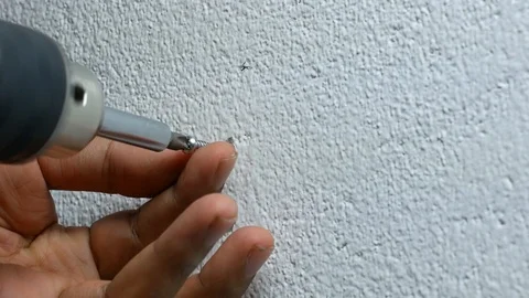 Man hand using electric screwdriver to tighten the screw into plastic plug , Stock Footage 89730779