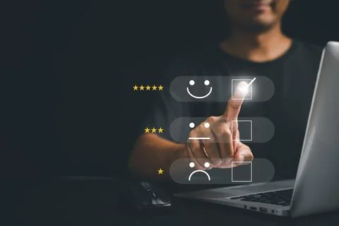 Man hand using laptop computer select 5-star popup with smile face icon Stock Photos