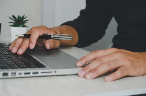 Man hand using laptop computer keyboard Stock Photos
