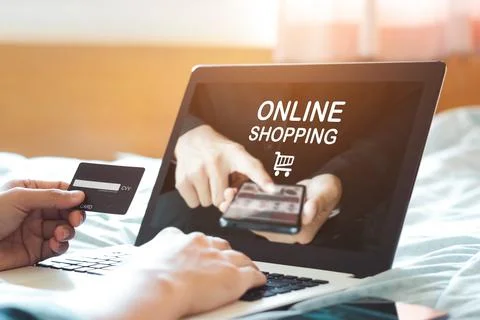 Man hand using laptop (Mockup website) and holding credit card for shopping.. Stock Photos
