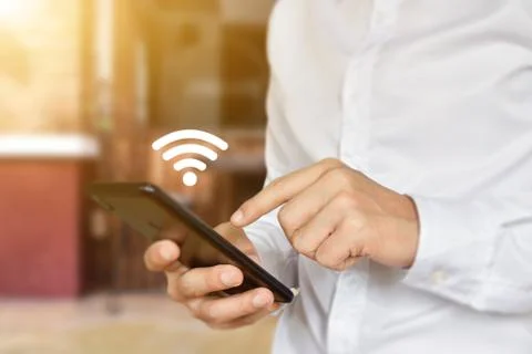Man hand using mobile smartphone with wifi icon. Stock Photos