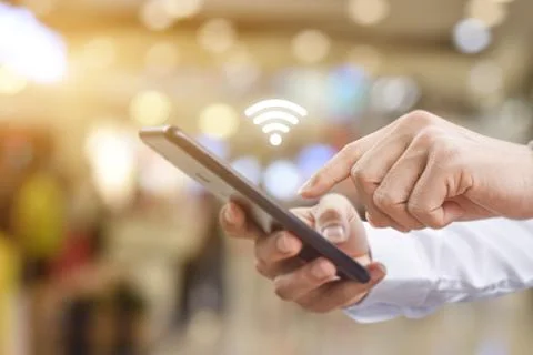 Man hand using mobile smartphone with wifi icon. Idea for business communicat Foto stock