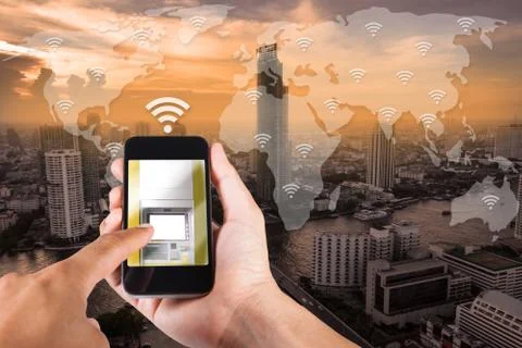 Man hand using smartphone mobile banking on top view cityscape in Bangkok, Th Stock Photos