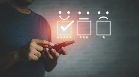 Man hand using smartphone with popup five star icon for feedback review sat.. Stock Photos