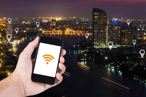Man hand using smartphone searching location on map pin on top view cityscape Stock Photos