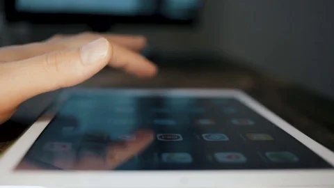 Man hand using tablet computer pc commuter in background The monitor in the Stock Footage 83164298