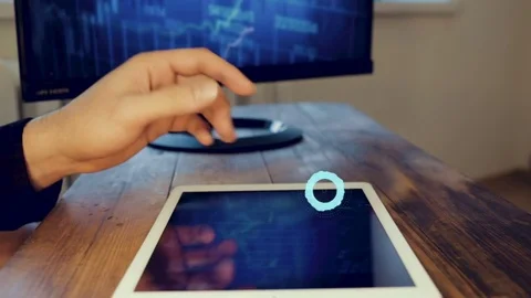 Man hand using tablet computer pc commuter in background The monitor in the Stock-Footage 83239014