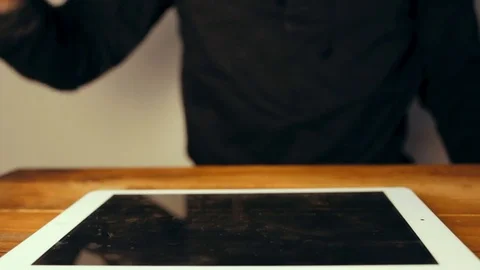Man hand using tablet computer pc commuter in background The monitor in the Stock Footage 83385376