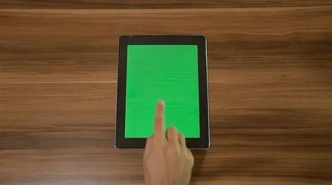 Man Hand Using Tablet with Green Singe Tap on the Background of Wooden Table Stock Footage 66298810