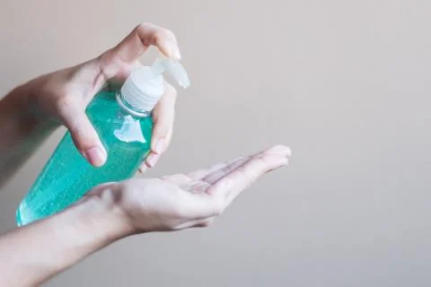 Man hand using wash hand sanitizer gel dispenser, against Novel coronavirus o Stock Photos