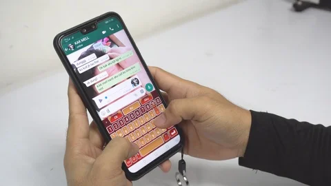 A man hand using WhatsApp on his Phone and Typing quickly with his hands Stock Footage 106791636