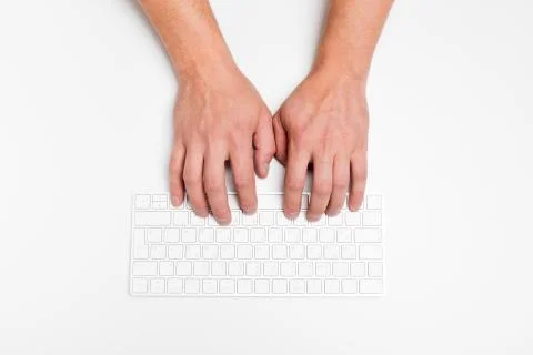 A man hand using a wireless keyboard isolated on white. Stock Photos