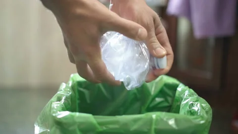 Man hand view while trashing used plastic bottle on separate garbage bin,recycle Stock Footage 148178782
