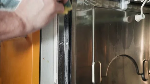 Man hand washes dirty surface in kitchen with sponge and washing agent Stock Footage 150420490