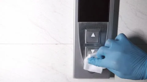 Man hand wiping down elevator buttons. Stock Footage 155895813