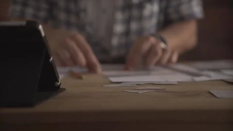 Man hand working attentively concentrated carefully on small detail of paper wor Stock Footage 138125638