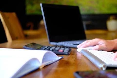 Man hand working on laptop computer on table and home quarantine new normal Stock Photos