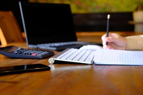 Man hand working on laptop computer on table and home quarantine new normal Stock Photos