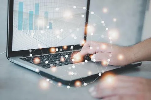 Man hand working on laptop computer with graph on the screen at home with l.. 스톡 사진