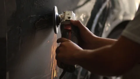  man hand works on the sheet and paint of a car with grinder 스톡 동영상 123799583